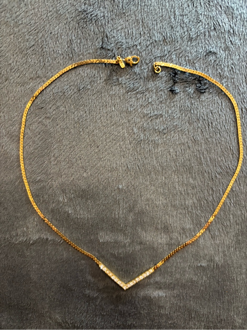 Vintage signed Monet gold tone chevron necklace w/rhinestone V-shape center bar